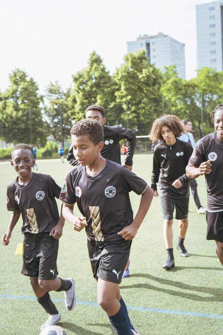 Small group soccer coaching with young players completing a technical drill